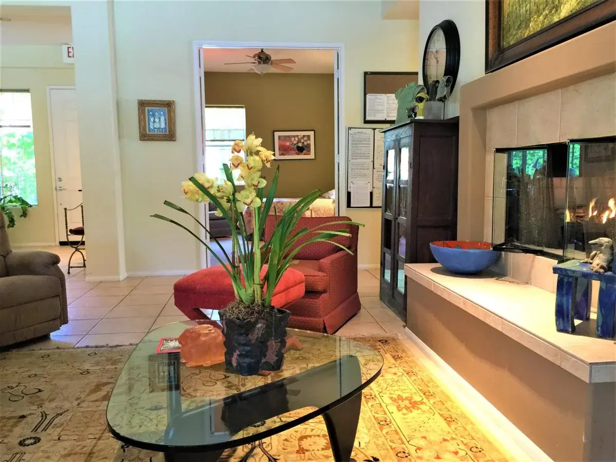 Living room with seating, flowers, and fireplace